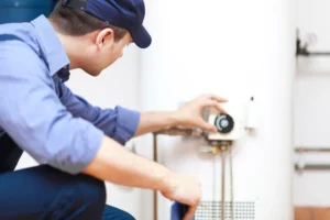 plumber adjusting water heater