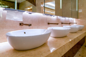 Upscale hotel bathroom with raised sinks.