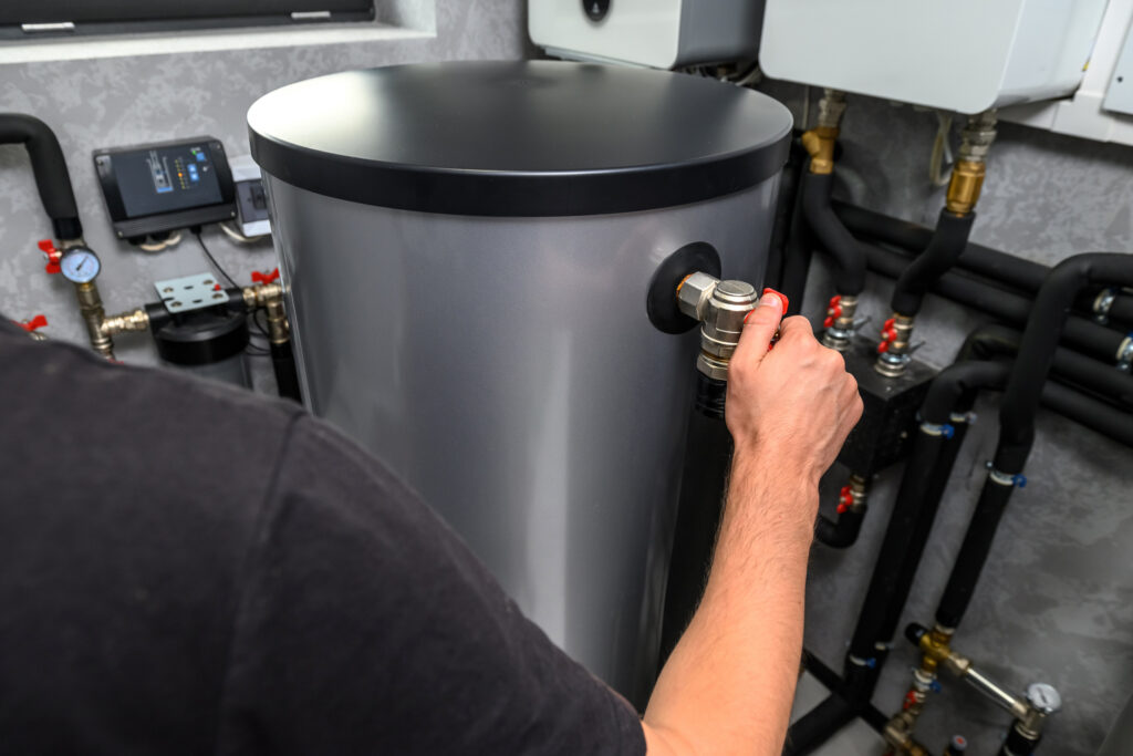 Plumber installing modern electric water heater