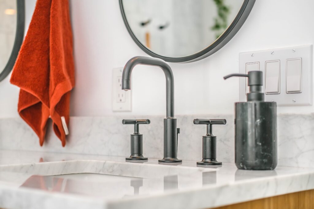 Marble-like bathroom sink with dark faucet