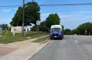 Leak Geeks plumbing van in front of the Bedford city sign.