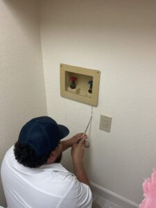 Leak Geeks plumber replacing the valves on a washing machine