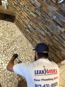 Leak Geeks plumber removing a shower drain to remove a clog